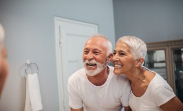 Cute mature couple brushing teeth